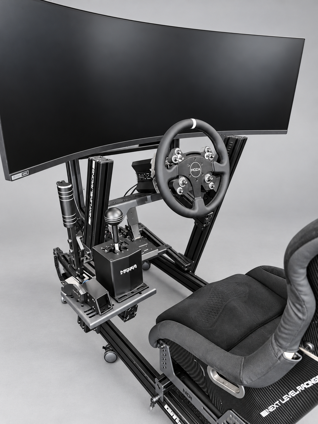 Sprint GT simulator close-up showing the 49-inch ultrawide monitor, MOZA CS wheel, HGP shifter, HBP handbrake and ES2 seat
