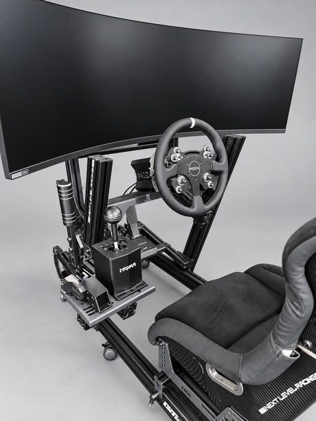 Sprint GT simulator close-up showing the 49-inch ultrawide monitor, MOZA CS wheel, HGP shifter, HBP handbrake and ES2 seat